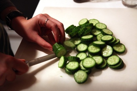 Cutting cucumbers for salad.